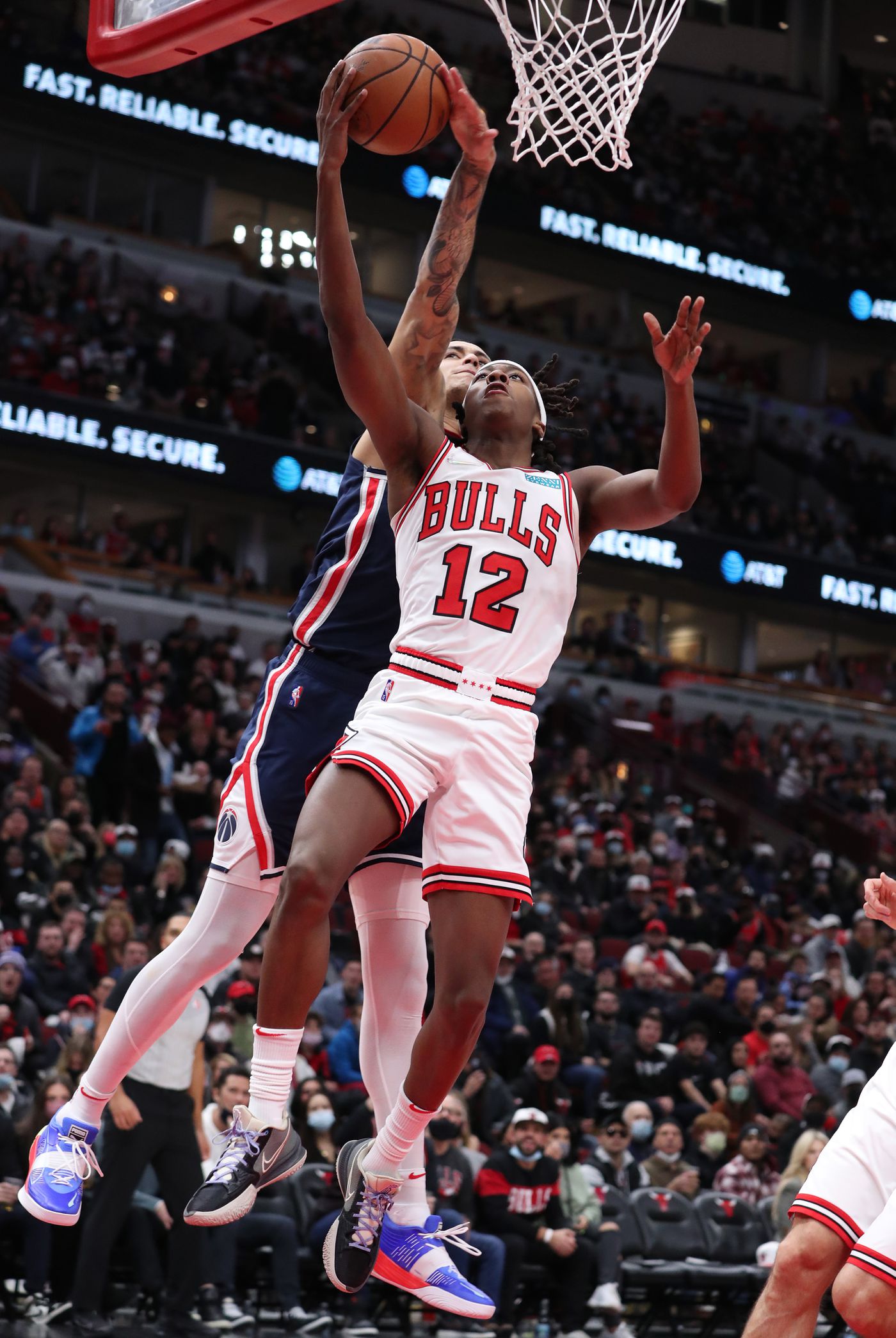 Chicago Bulls guard Ayo Dosunmu (12) is fouled by Washington Wizards forward Kyle Kuzma (33) during a basket attempt in the first quarter at United Center on Jan. 7, 2022, in Chicago.