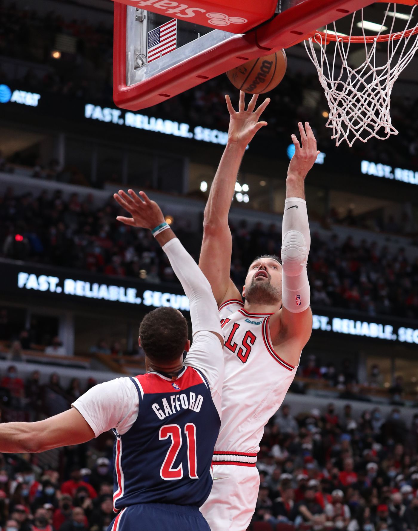 Chicago Bulls center Nikola Vucevic (9) makes a layup as Washington Wizards center Daniel Gafford (21) defends in the first quarter at United Center on Jan. 7, 2022, in Chicago.