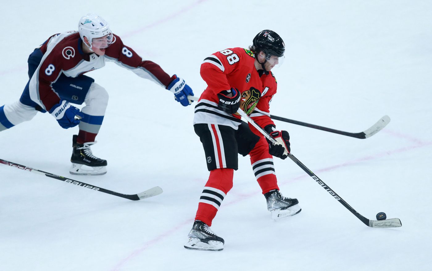 Avalanche defenseman Cale Makar (8) tries to block a shot attempt by Blackhawks right wing Patrick Kane (88) in the second period.