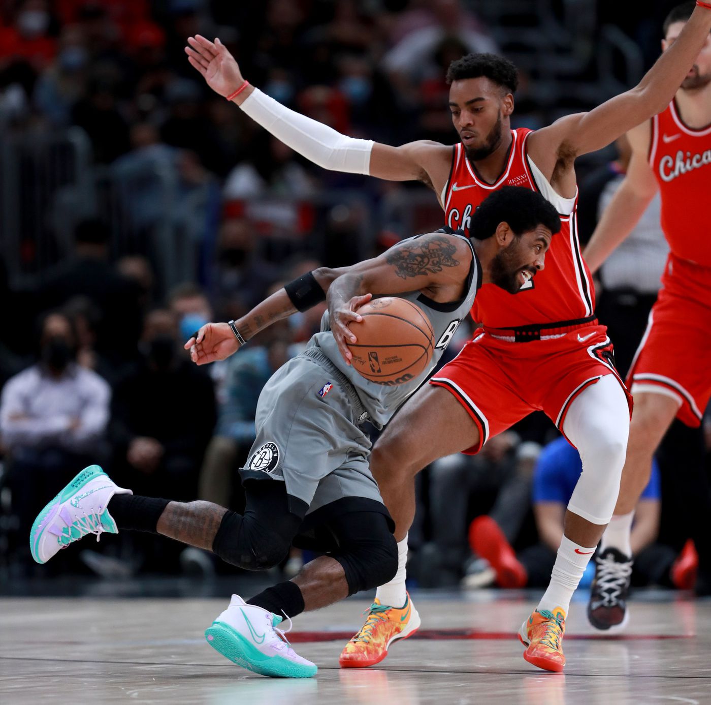 Nets guard Kyrie Irving (11) drives on Bulls forward Troy Brown Jr. (7) in the first half.