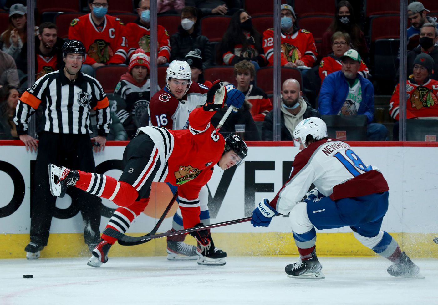 Blackhawks center Henrik Borgström (13) loses his balance while battling the Avalanche in the first period.