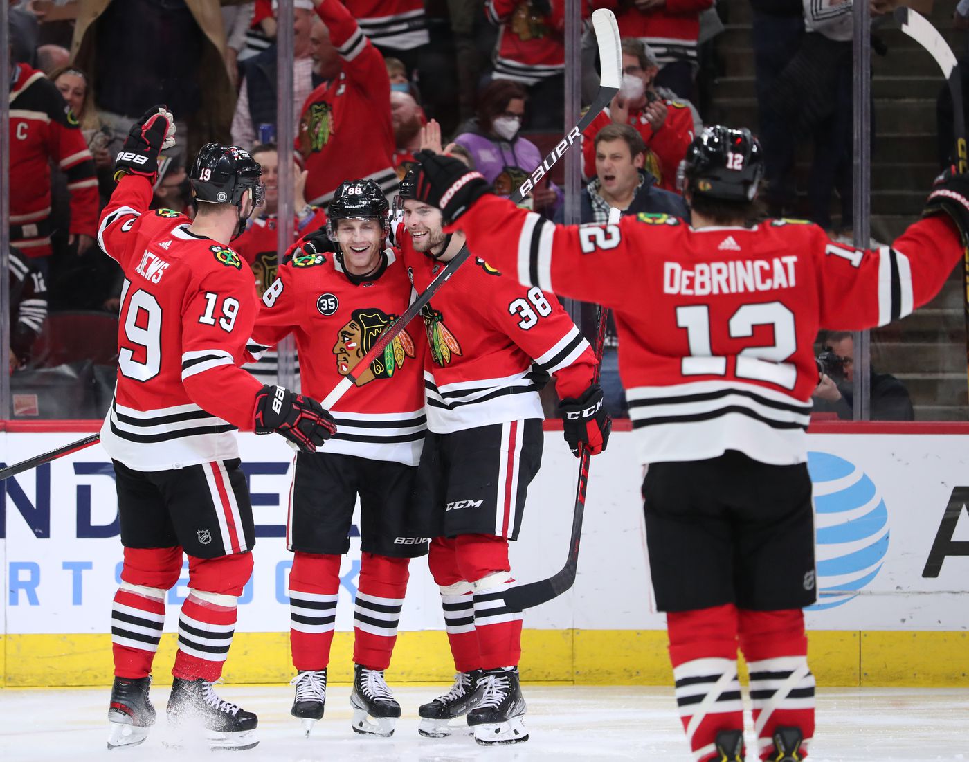 Chicago Blackhawks players congratulate right wing Patrick Kane (88) after Kane scores a goal in the third period against the Montreal Canadiens at United Center on Jan. 13, 2022, in Chicago.