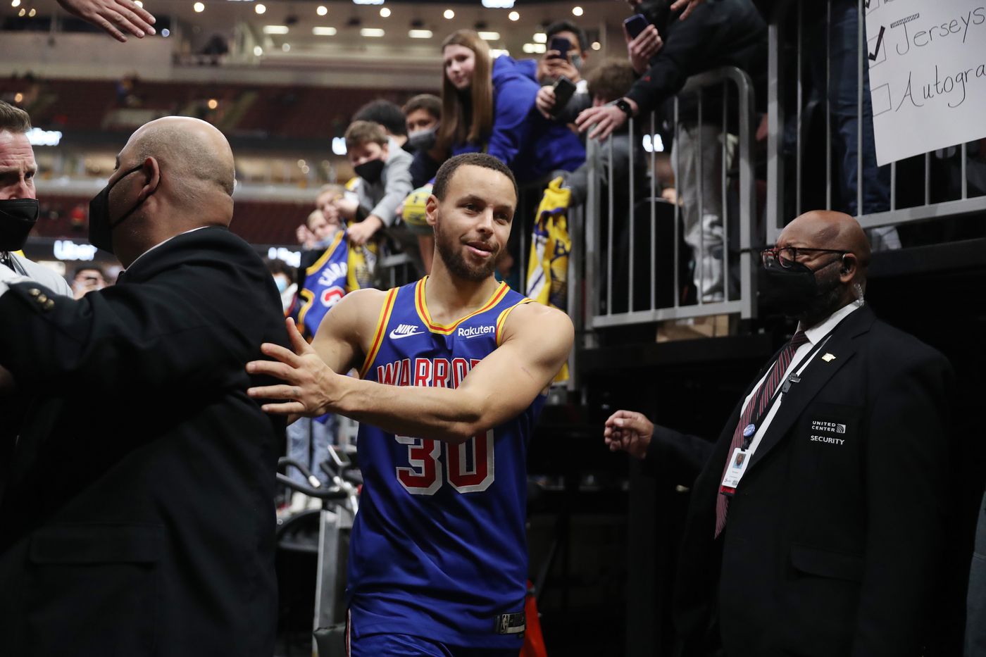 Golden State Warriors guard Stephen Curry (30) maneuvers past security on his way to the locker room after a 138-96 win over the Chicago Bulls at United Center on Jan. 14, 2022, in Chicago.