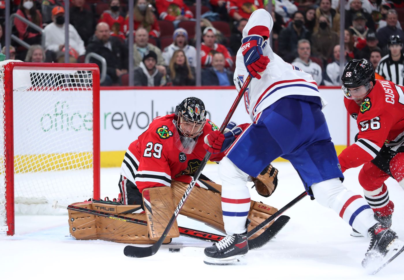 Chicago Blackhawks goaltender Marc-Andre Fleury (29) deflects a shot on goal by Montreal Canadiens center Nick Suzuki (14) in overtime at United Center on Jan. 13, 2022, in Chicago.