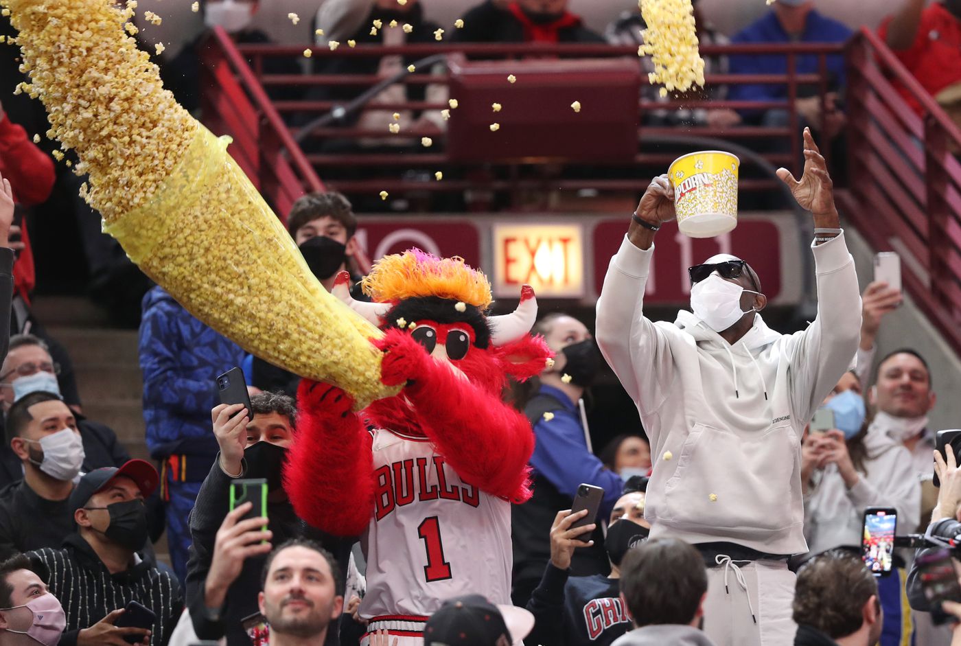 Benny the Bull and former NFL player Terrell Owens throw popcorn on fans during a timeout in the first quarter between the Chicago Bulls and Golden State Warriors at United Center on Jan. 14, 2022, in Chicago.