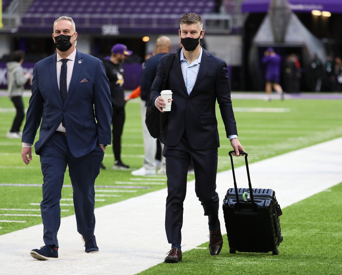 Bears GM Ryan Pace wheels his suitcase across the field before the start of a game against the Vikings at U.S. Bank Stadium on Jan. 9, 2022.