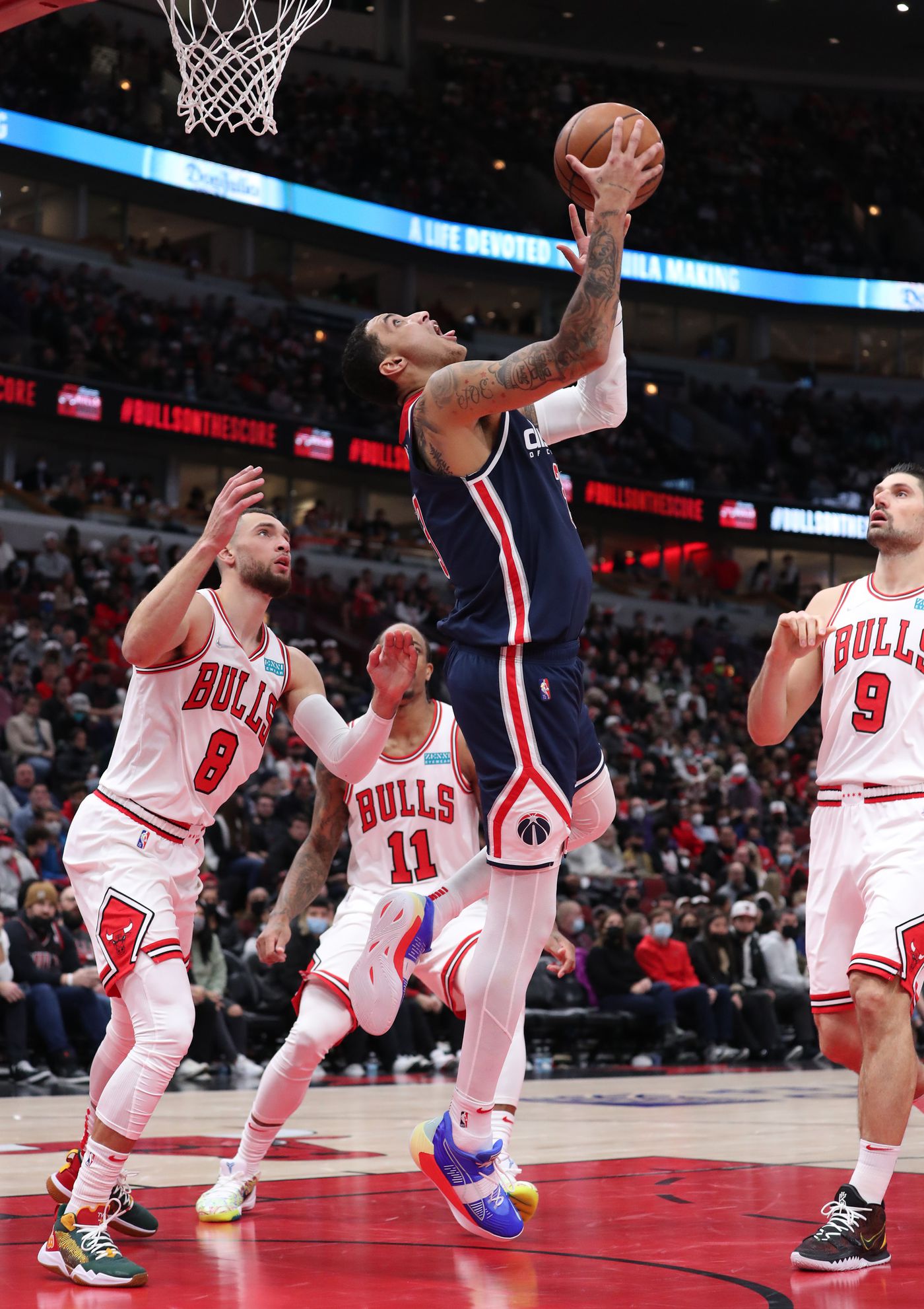 Washington Wizards forward Kyle Kuzma (33) makes a reverse layup and draws a foul in the third quarter against the Chicago Bulls at United Center on Jan. 7, 2022, in Chicago.
