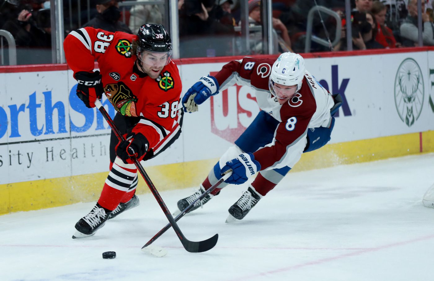 Blackhawks left wing Brandon Hagel (38) and Avalanche defenseman Cale Makar (8) battle in the first period.
