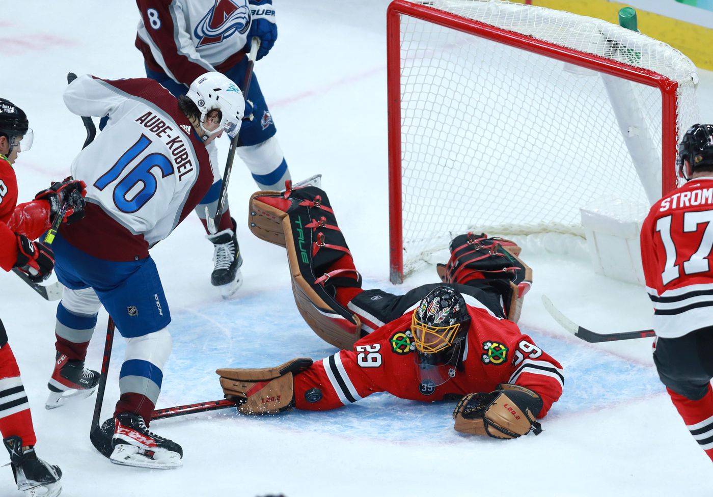 Blackhawks goaltender Marc-André Fleury (29) tries to fall on the puck as Avalanche right wing Nicolas Aube-Kubel (16) tries to score in the first period.