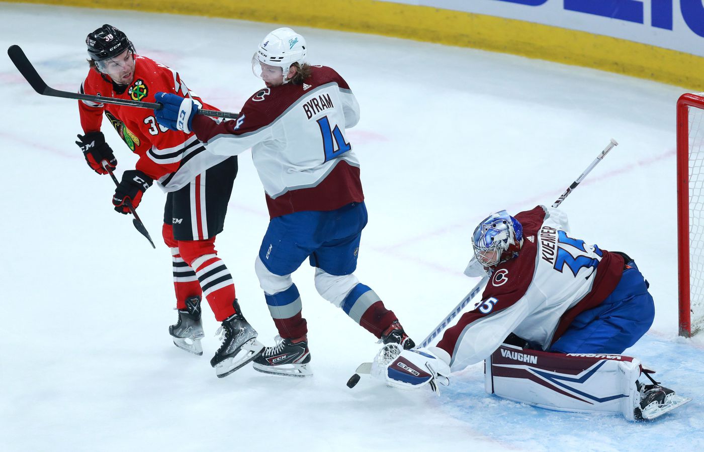 Avalanche goaltender Darcy Kuemper (35) makes a save as Blackhawks left wing Brandon Hagel (left) tries to score in the second period.