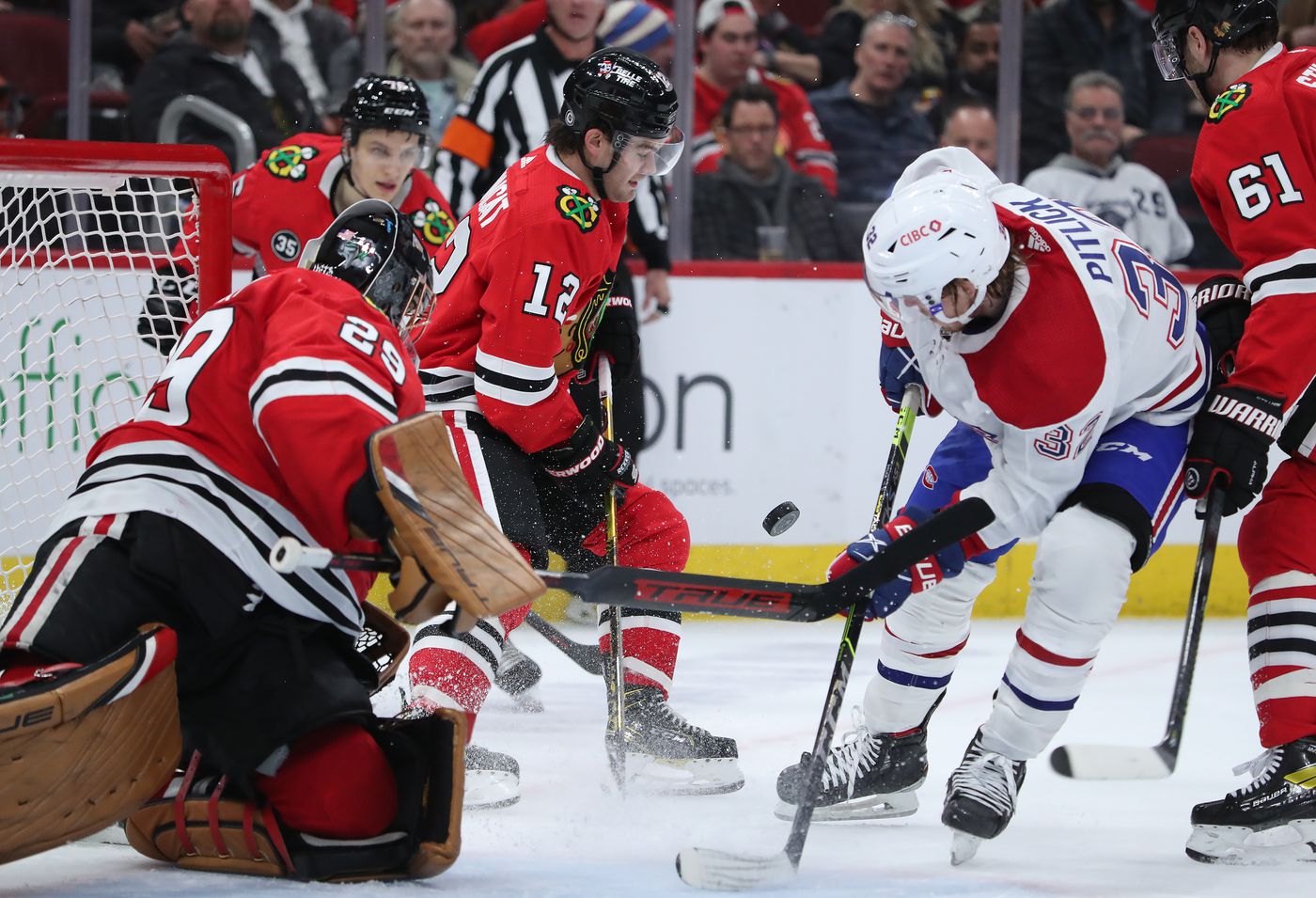 Chicago Blackhawks left wing Alex DeBrincat (12) handles the puck in the second period against the Montreal Canadiens at United Center on Jan. 13, 2022, in Chicago.