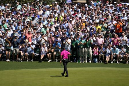 Tiger Woods shoots a 1-under 71 at the Masters in his 1st competitive round since a car wreck 14 months ago