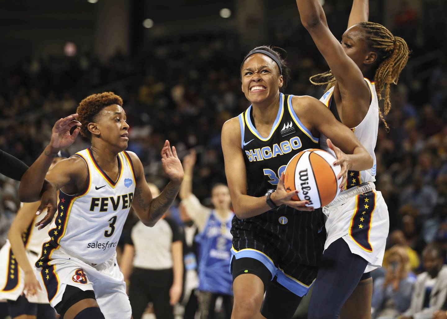 Chicago Sky forward Azurá Stevens drives past the Indiana Fever's Danielle Robinson (3) and Queen Egbo on May 24, 2022, at Wintrust Arena.
