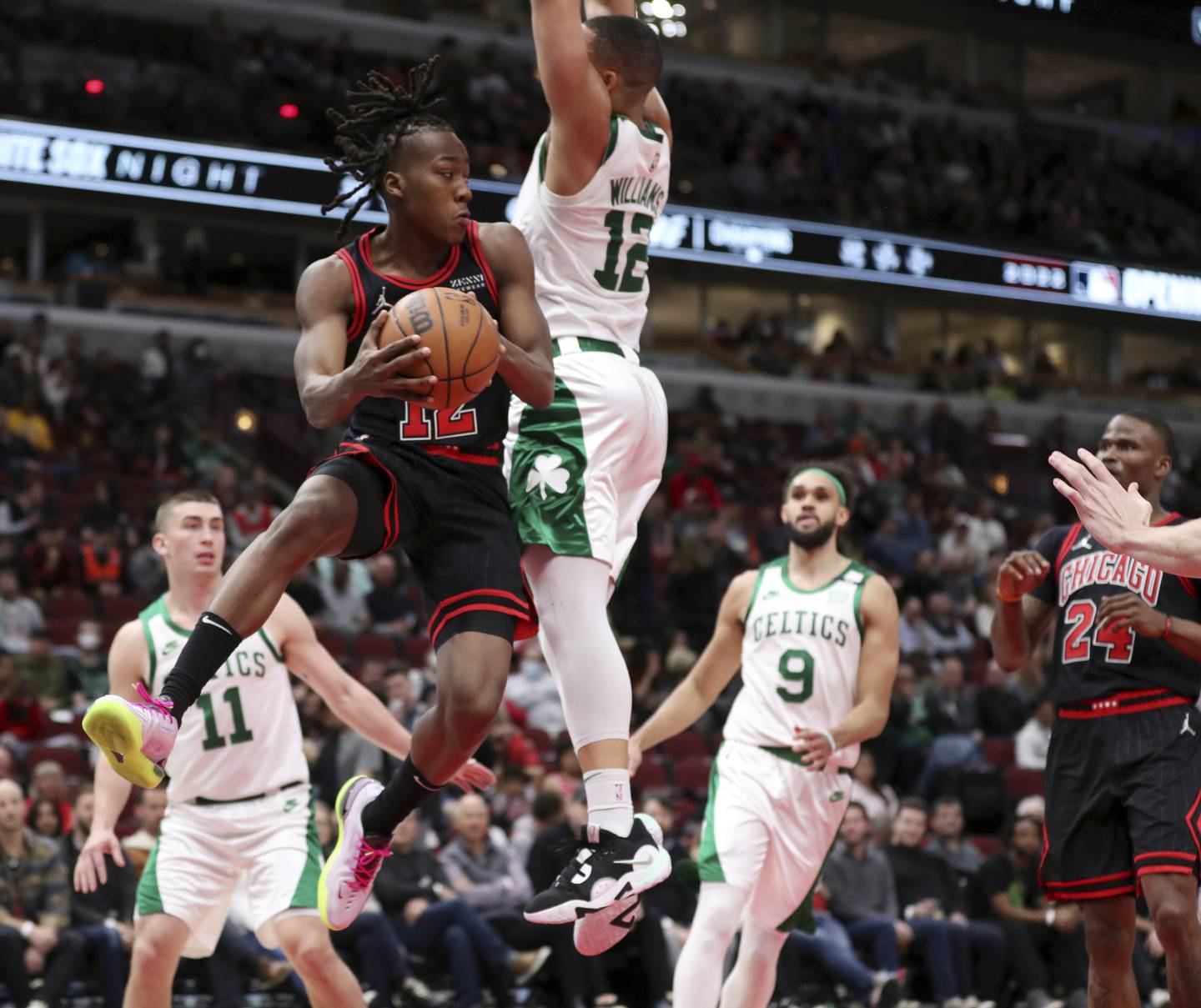 Bulls guard Ayo Dosunmu drives against Celtics forward Grant Williams in the second half on, April 6, 2022, at the United Center. 
