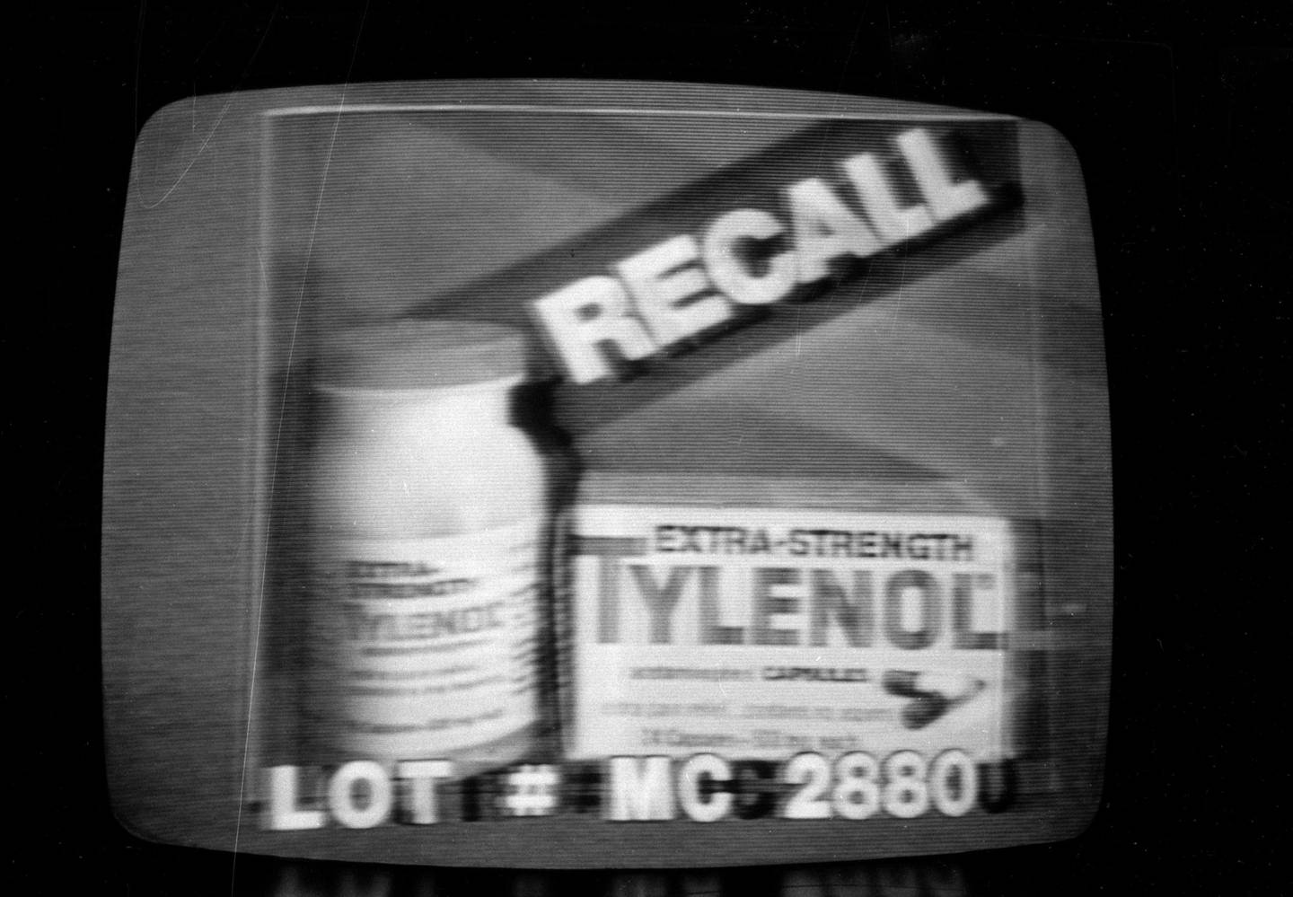 A photograph of a television screen shows the specific lot number for a batch of Extra-Strength Tylenol that was the first to be recalled. 