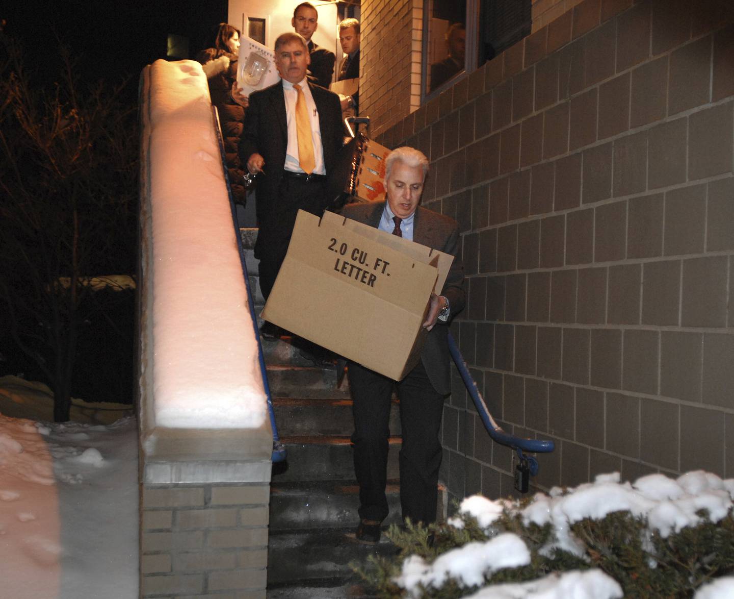 FBI agents carry away boxes after searching the apartment of James Lewis in Cambridge, Massachusetts, in 2009. 