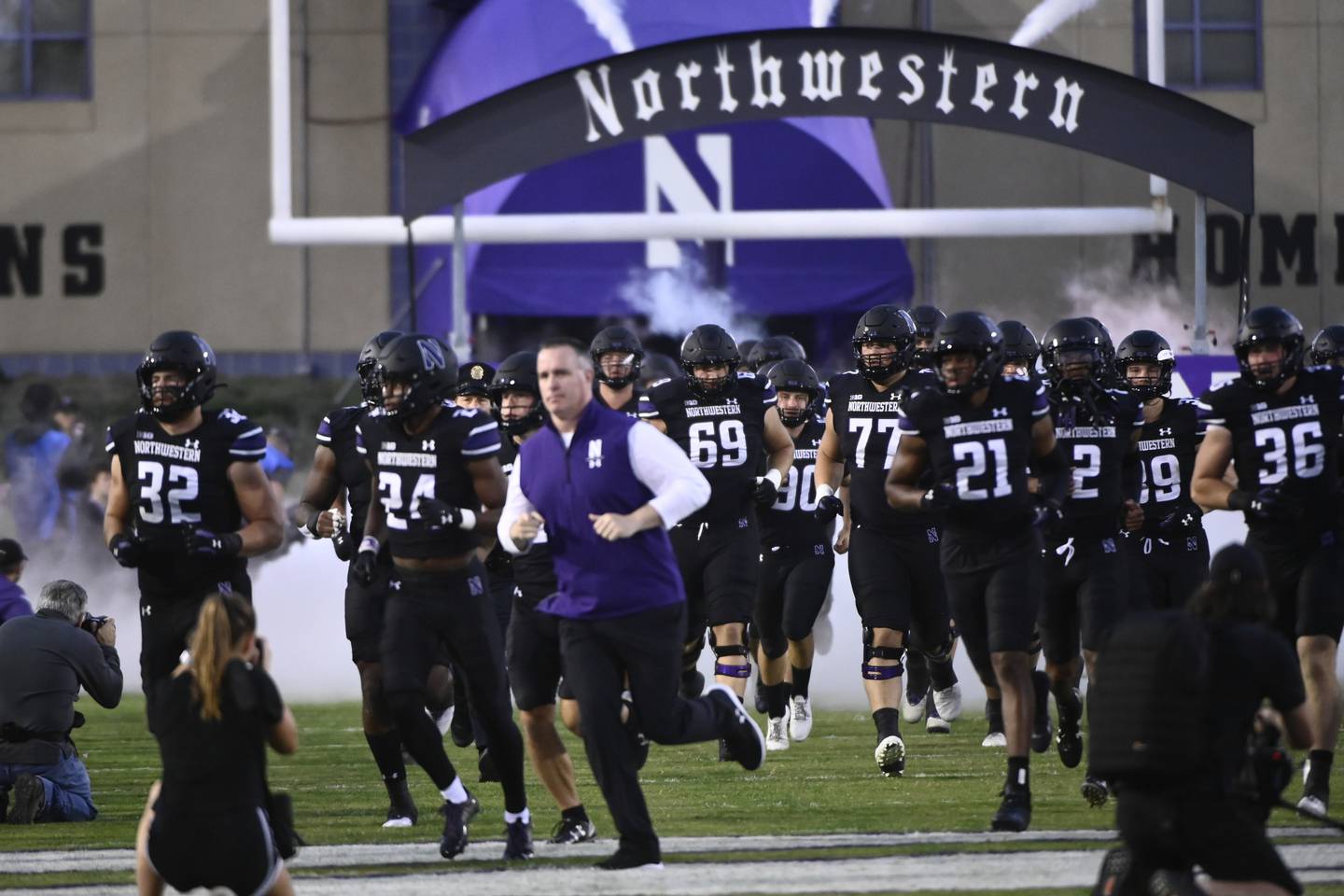 Northwestern coach Pat Fitzgerald, center, leads the team onto the field before a game against Miami-Ohio on Sept. 24.