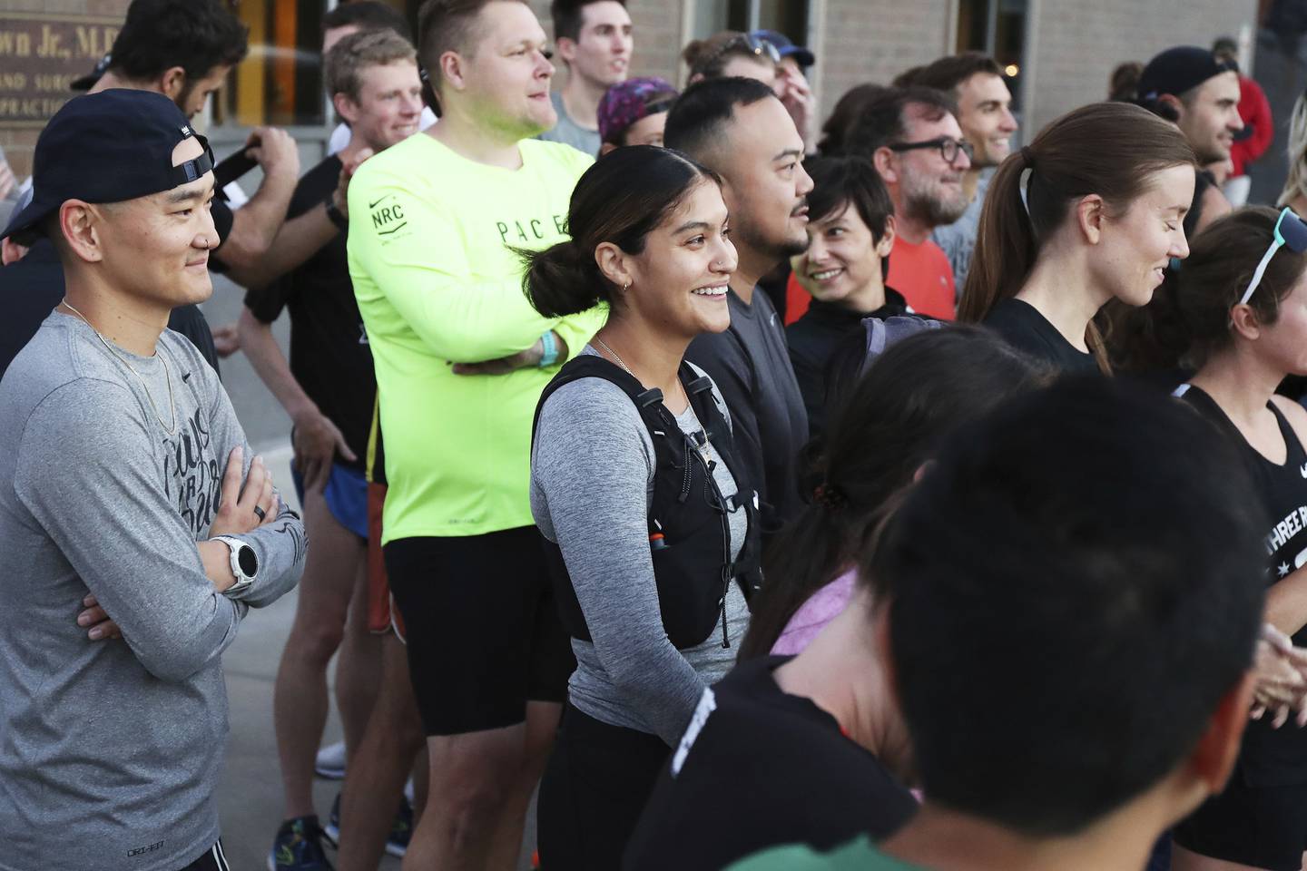 Crystal Rosales, center, in gray, is seen in Chicago's Logan Square neighborhood with her running group called Three Run Two before the start of a run on Sept. 29, 2022. Rosales thought something was off when her watch mileage didn’t match up with the route of Sunday's 13.1-mile HOKA One One Chicago Half Marathon. 