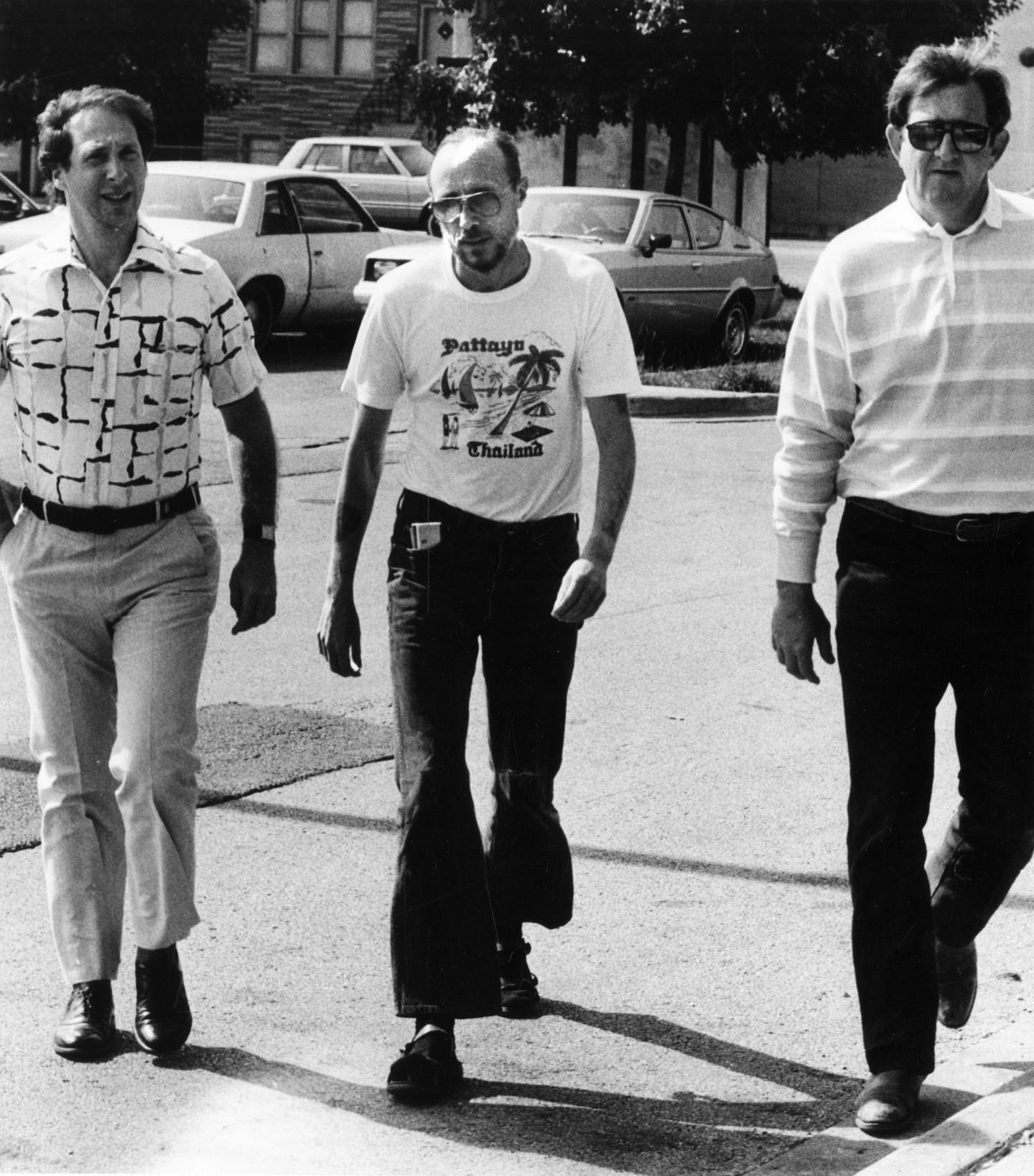 Roger Arnold, center, is escorted by attorney Thomas Royce, right, as he walked into the Area 6 police station to surrender after the 1983 fatal shooting of John Stanisha. 