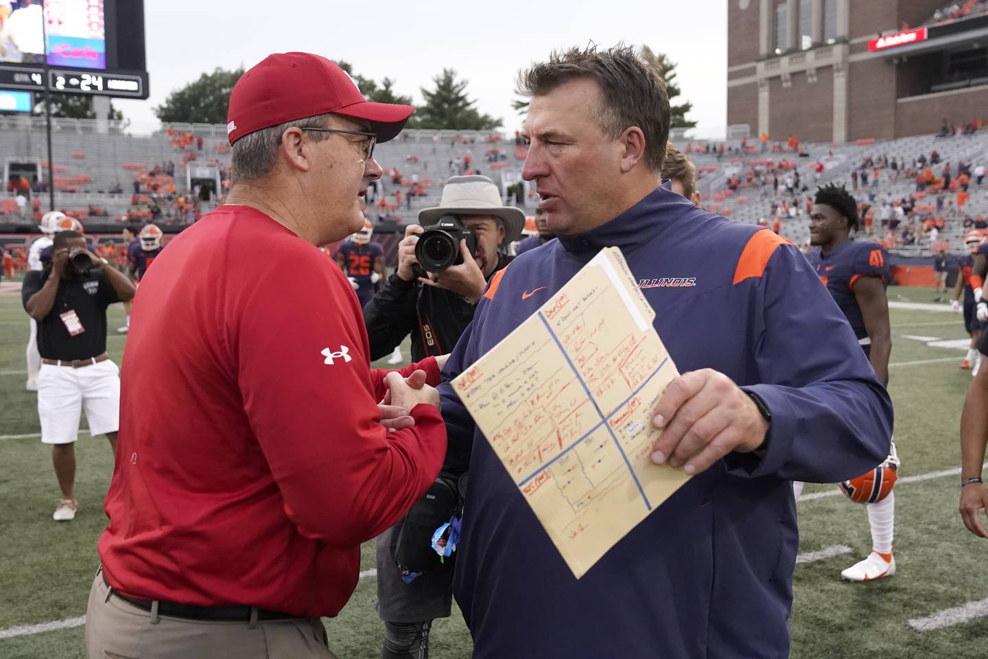 Wisconsin coach Paul Chryst, left, and Illinois coach Bret Bielema meet after the Badgers' 24-0 victory on Oct. 9, 2021, in Champaign.