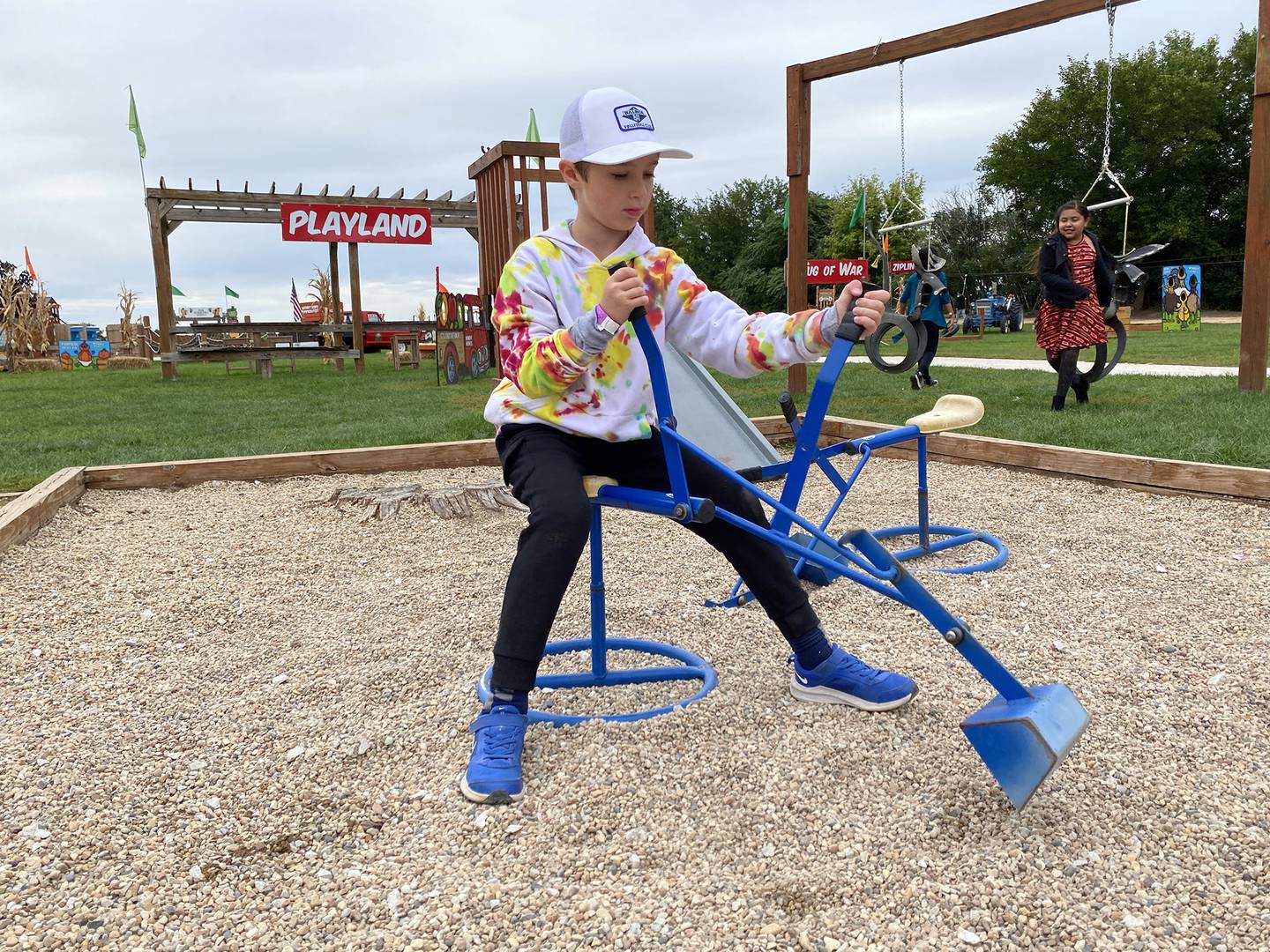 Activities inside the paid attraction area at Windy Acres Farm, 37W446 Fabyan Parkway, Geneva, include gravel diggers and playground equipment.