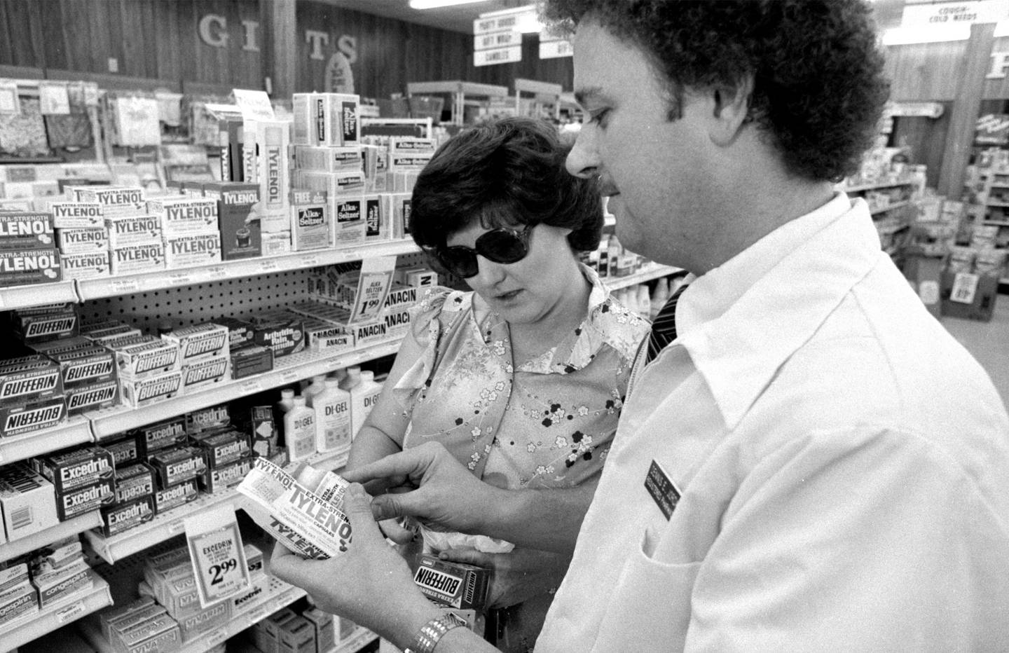 Pharmacist Dennis Jordan, right, checks lot codes on bottles of Extra-Strength Tylenol at the Westmont Pharmacy as he removes them from the shelves on Sept. 30, 1982.