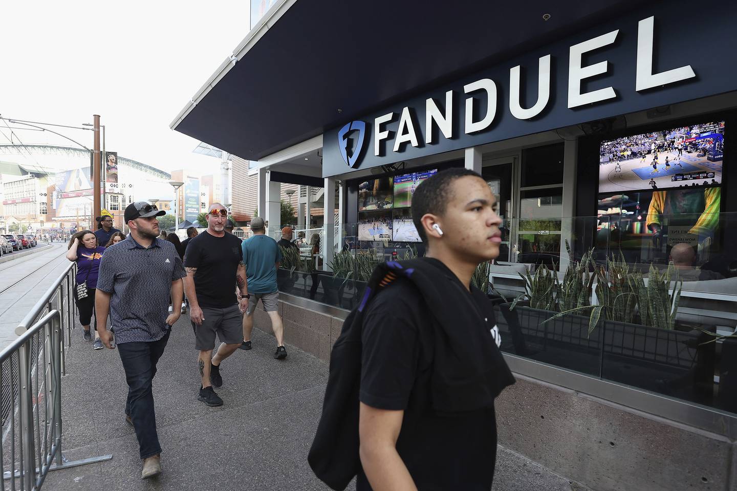 Fans walk past a Fanduel sports betting location at Footprint Center before Game Five of the Western Conference First Round NBA Playoffs between the Phoenix Suns and the New Orleans Pelicans on April 26, 2022, in Phoenix.  