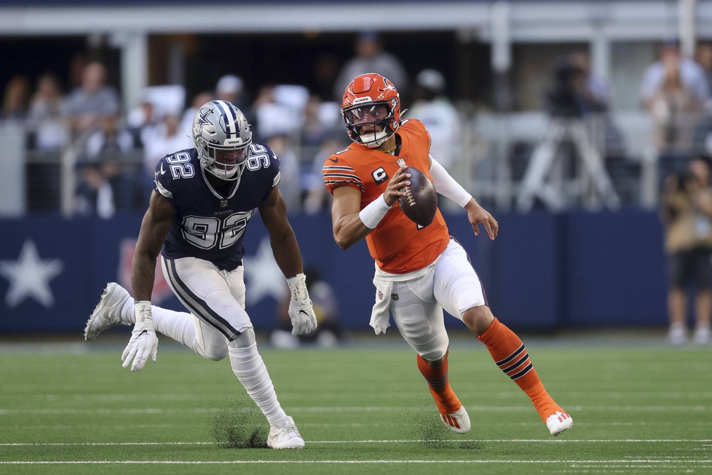 Cowboys defensive end Dorance Armstrong chases Bears quarterback Justin Fields while he runs the ball during the first quarter at AT&T Stadium on Oct. 30, 2022.