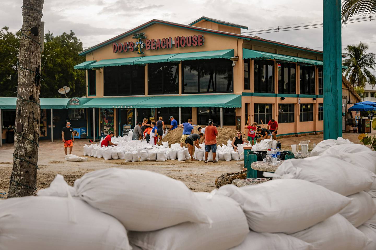Staff members of Doc's Beach House fill sandbags outside the restaurant in Bonita Springs, Florida, in preparation for Hurricane Ian on Sept. 26, 2022. 