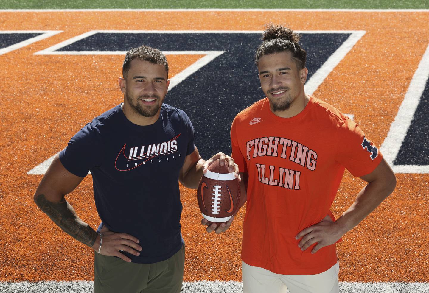 Illini running back Chase Brown, left, and his twin brother, defensive back Sydney Brown, stand for a portrait at Memorial Stadium on Oct. 19, 2022.
