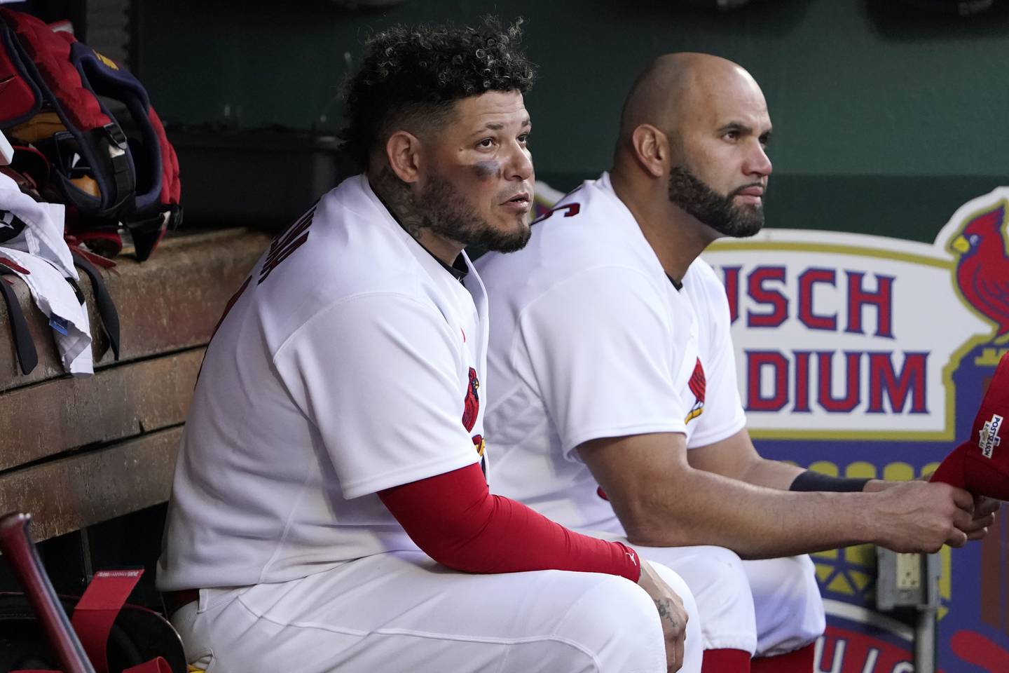 Cardinals catcher Yadier Molina, left, and designated hitter Albert Pujols watch from the dugout during the ninth inning of Game 1 of a wild-card series against the Phillies. 