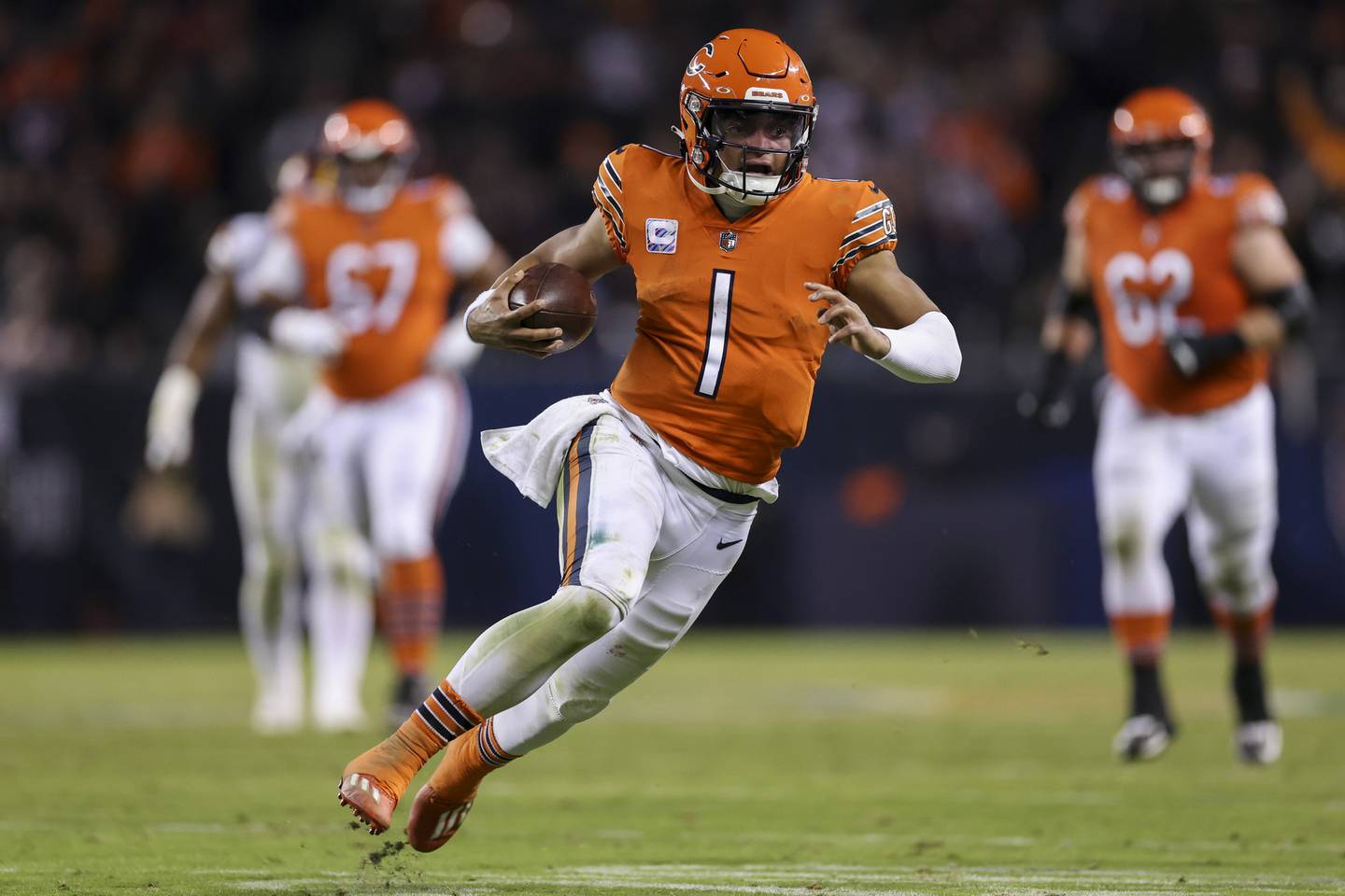Quarterback Justin Fields runs the ball on the Bears final drive during the fourth quarter against the Commanders on Thursday at Soldier Field. 