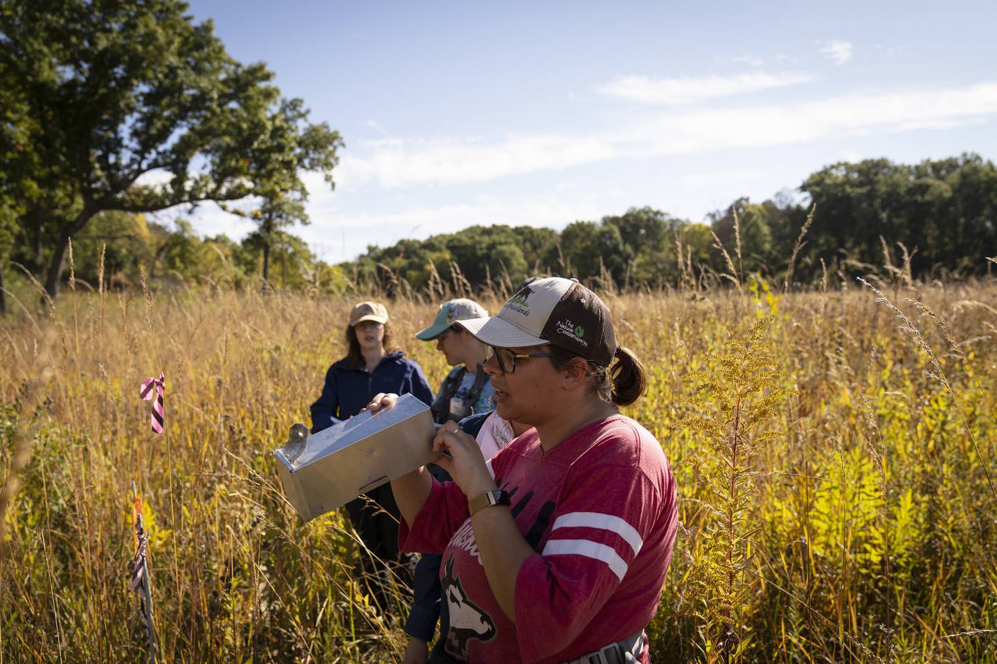 Erin Rowland-Schaefe, a restoration ecologist doctoral candidate at Northern Illinois University, gathers small mammal specimens at Nachusa Grasslands on Oct. 5, 2022.   