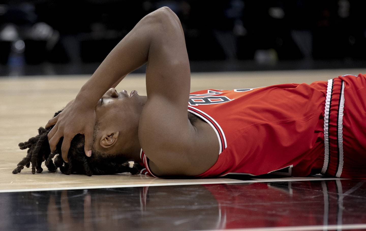 Bulls guard Ayo Dosunmu holds his head after colliding with a knee during the second half against the Spurs on Friday, Oct. 28, 2022, in San Antonio.