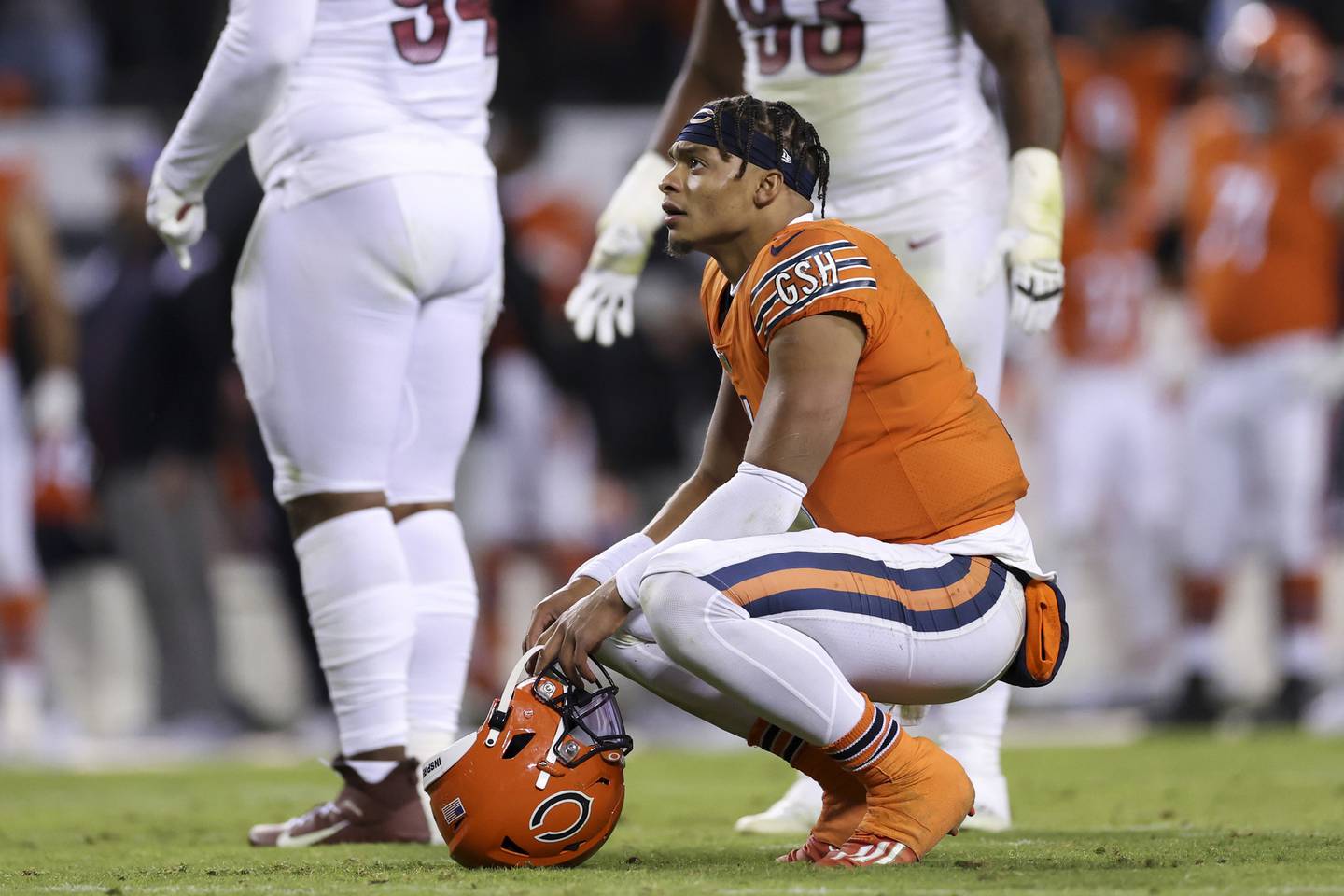 Quarterback Justin Fields crouches after receiver Darnell Mooney caught a pass short of the goal during the final minute Thursday at Soldier Field. 