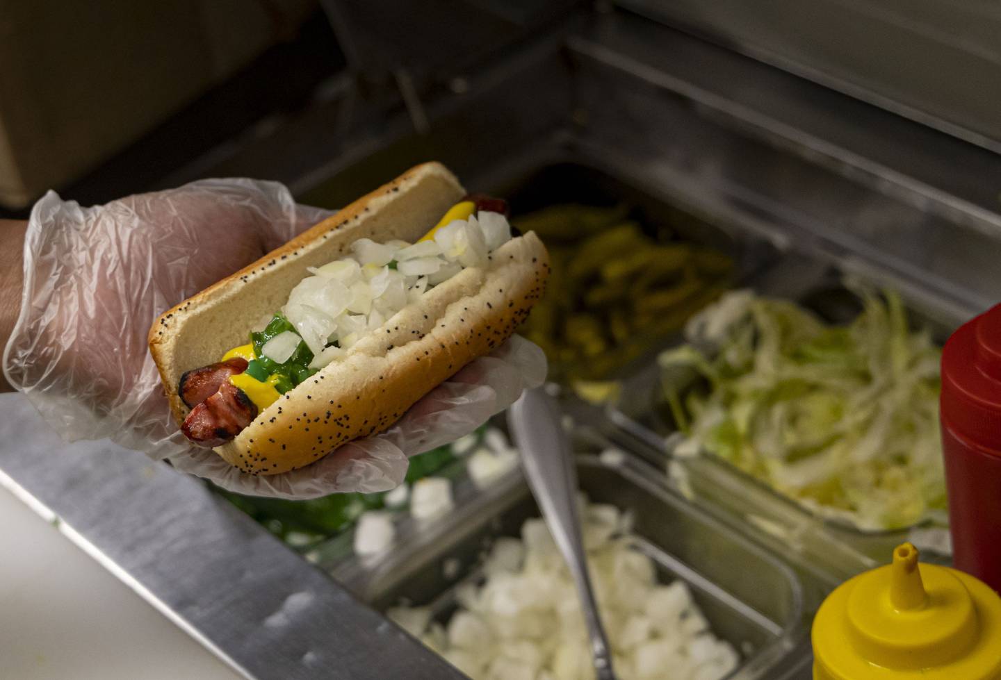 A char dog is prepared with all the toppings at The Wiener’s Circle.
