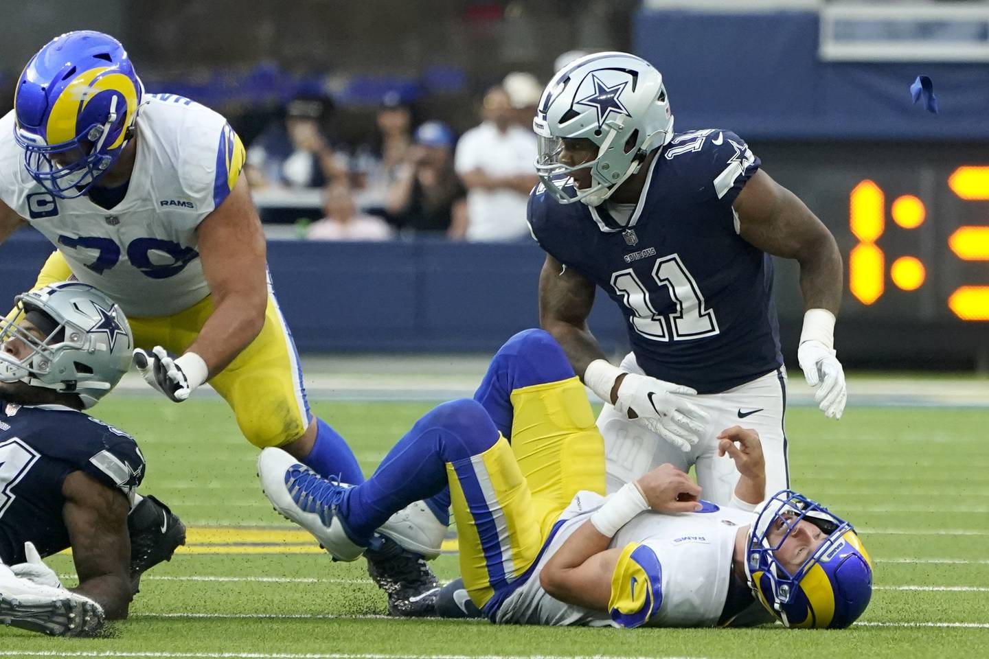 Rams quarterback Matthew Stafford, bottom, loses the ball after being sacked by Cowboys linebacker Micah Parsons (11) on Oct. 9, 2022, in Inglewood, Calif.