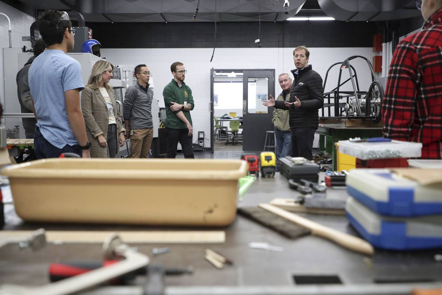 NASCAR driver Brad Keselowski, second from right, talks with students and staff inside the advanced manufacturing lab at Elk Grove Village High School on Oct. 17, 2022.  