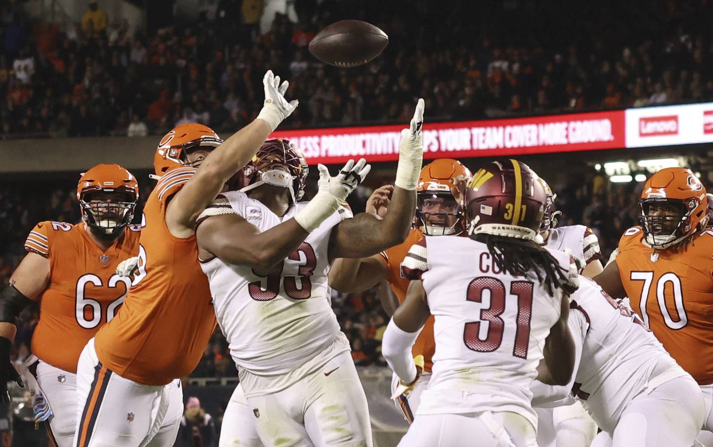 Commanders defensive tackle Jonathan Allen (93) looks up to intercept a Justin Fields pass in the first quarter Thursday at Soldier Field. 