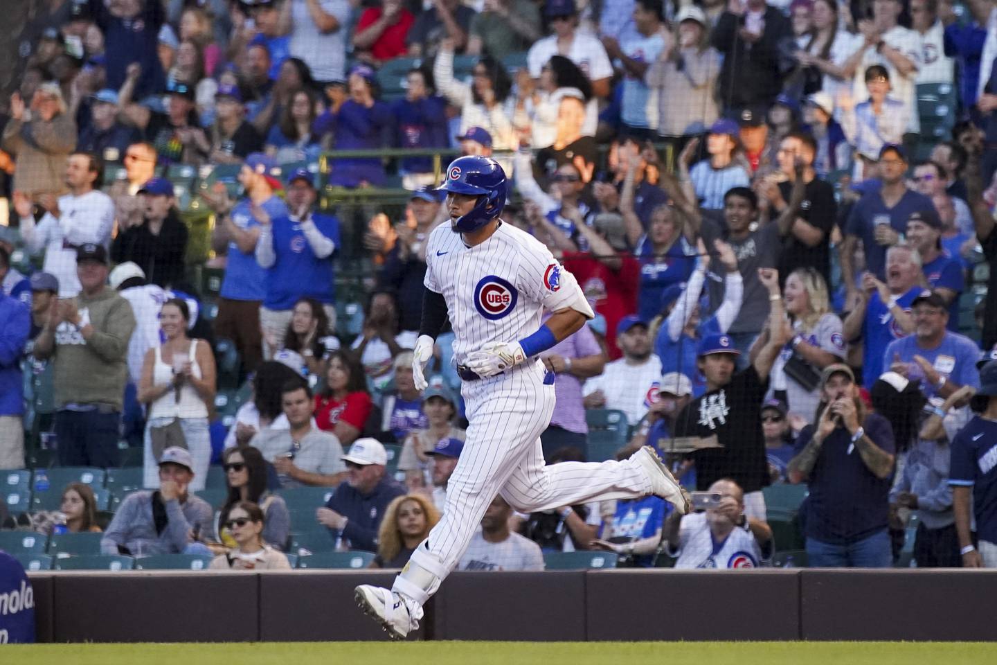 Cubs right fielder Seiya Suzuki rounds the bases after hitting a solo home run against the Nationals on Aug. 9 at Wrigley Field. 