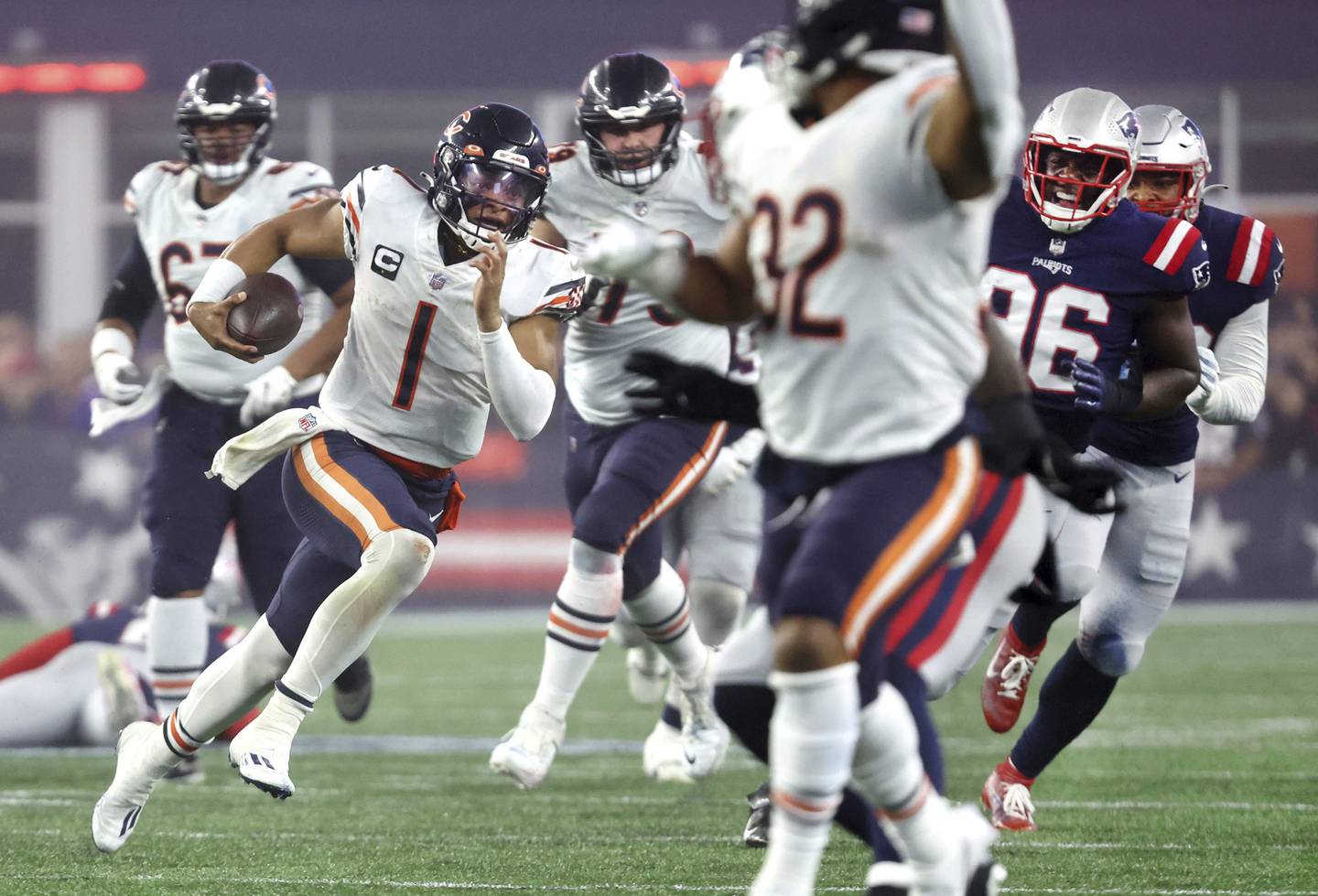 Bears quarterback Justin Fields (1) breaks free for a first down on third-and-15 in the second quarter against the Patriots on Monday, Oct. 24, 2022, at Gillette Stadium in Foxborough, Mass.