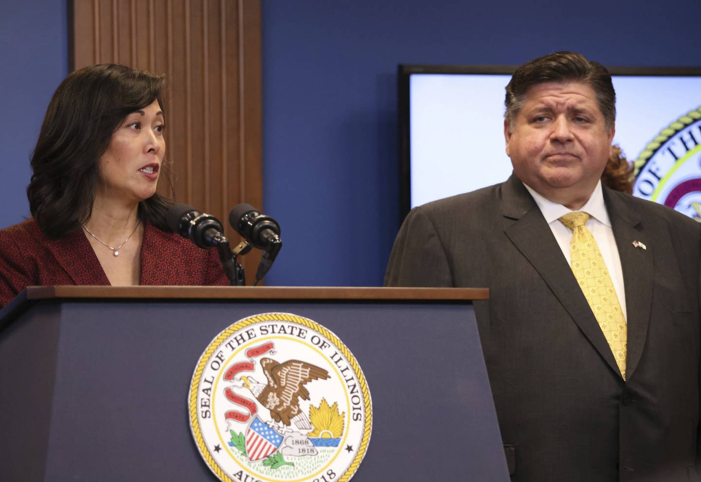 IDHS Secretary Grace Hou speaks alongside Gov. J.B. Pritzker during a news conference in Chicago on Sept. 14, 2022. 