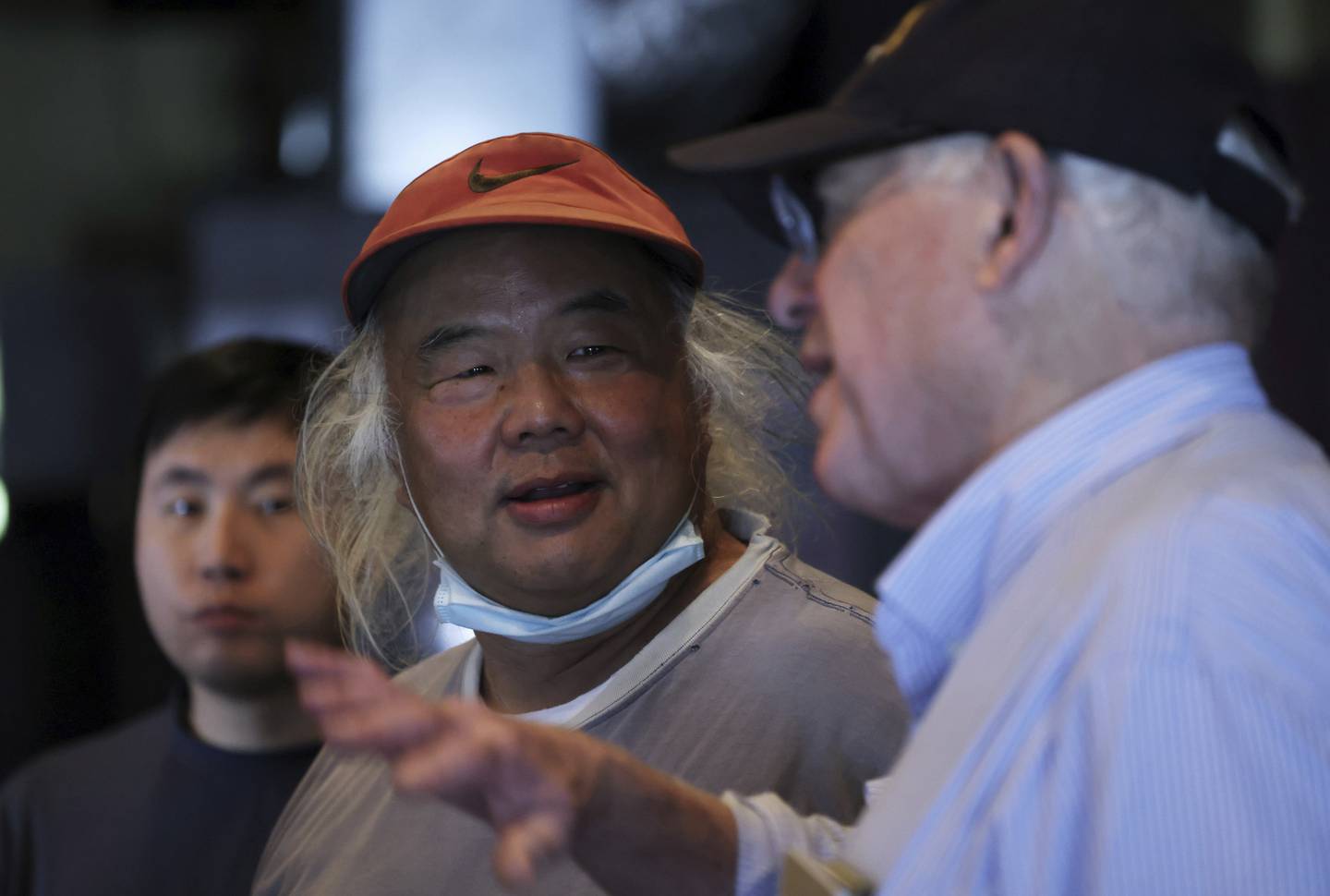 Businessperson Randy Jue, center, talks with former Gov. Pat Quinn during a campaign event for Illinois House candidate Hoan Huynh.