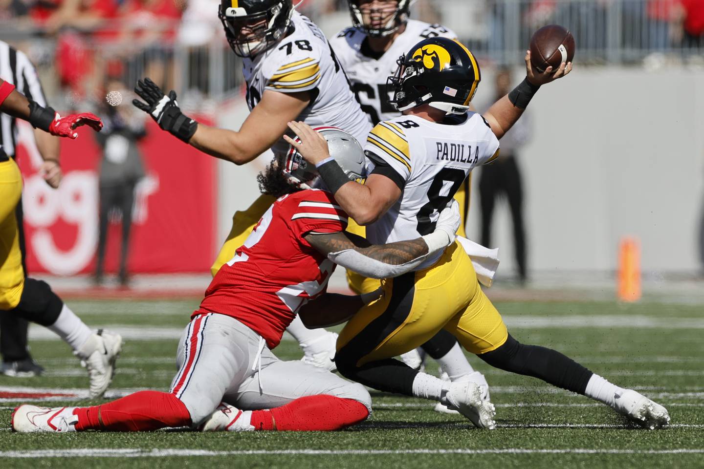 Ohio State linebacker Steele Chambers, left, forces Iowa quarterback Alex Padilla to throw an incomplete pass during a game on Saturday in Columbus, Ohio.