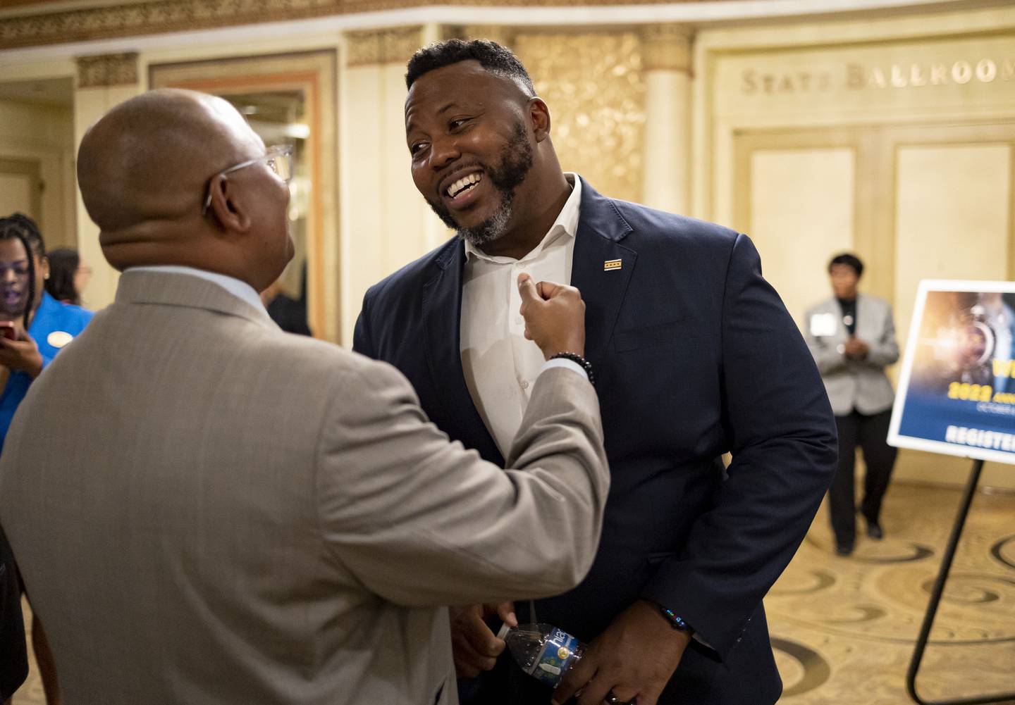 State Rep. Kam Buckner, right, greets people on Oct. 6, 2022, at the Palmer House Hilton during the Illinois Chamber of Commerce's annual meeting.