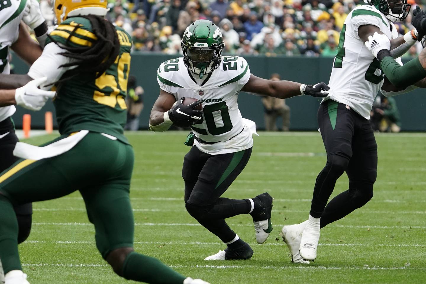 Jets running back Breece Hall (20) breaks upfield during the first half against the Packers on Sunday, Oct. 16, 2022, in Green Bay.