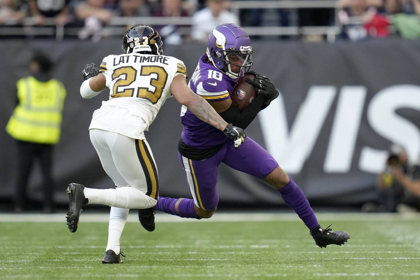 Vikings wide receiver Justin Jefferson is tackled by Saints cornerback Marshon Lattimore on Sunday at Tottenham Hotspur Stadium in London. 
