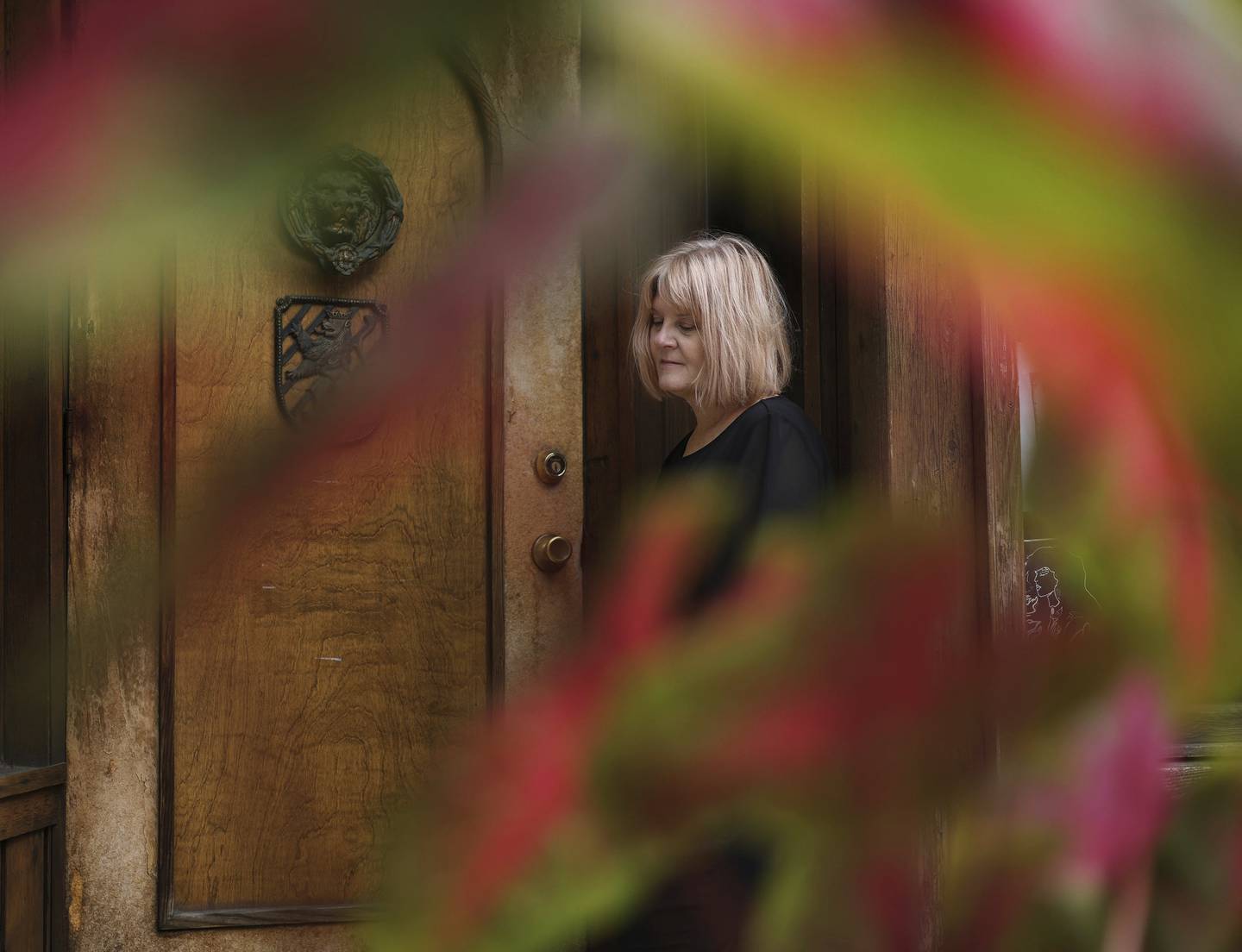 Laurie Edling stands in the doorway of Lilly’s bar in September, near where her father, John Stanisha, was fatally shot. Edling once drove to Springfield to plead with a parole board to keep her father’s killer behind bars. 