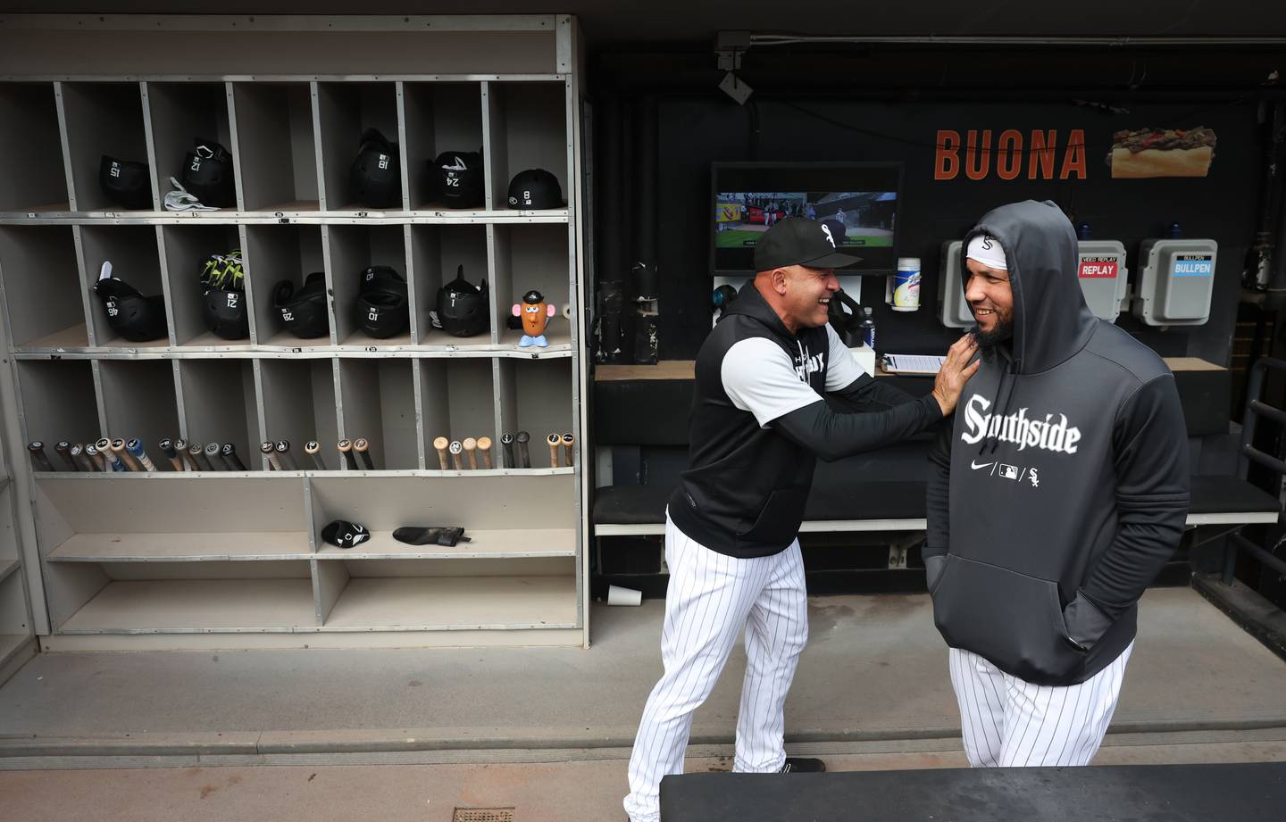White Sox acting manager Miguel Cairo and first baseman José Abreu laugh while watching a fan dressed as a banana before a game against the Twins at Guaranteed Rate Field on Oct. 5, 2022.