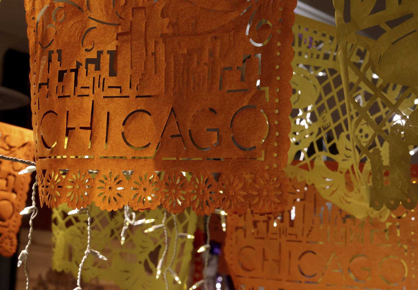 Papel Picado, a type of punched or perforated tissue paper, with images of Chicago and Day of the Dead figures is sold at Colores Mexicanos.
